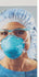 Clinician in a surgical cap and eyewear wearing the 3M 1860 N95 respirator