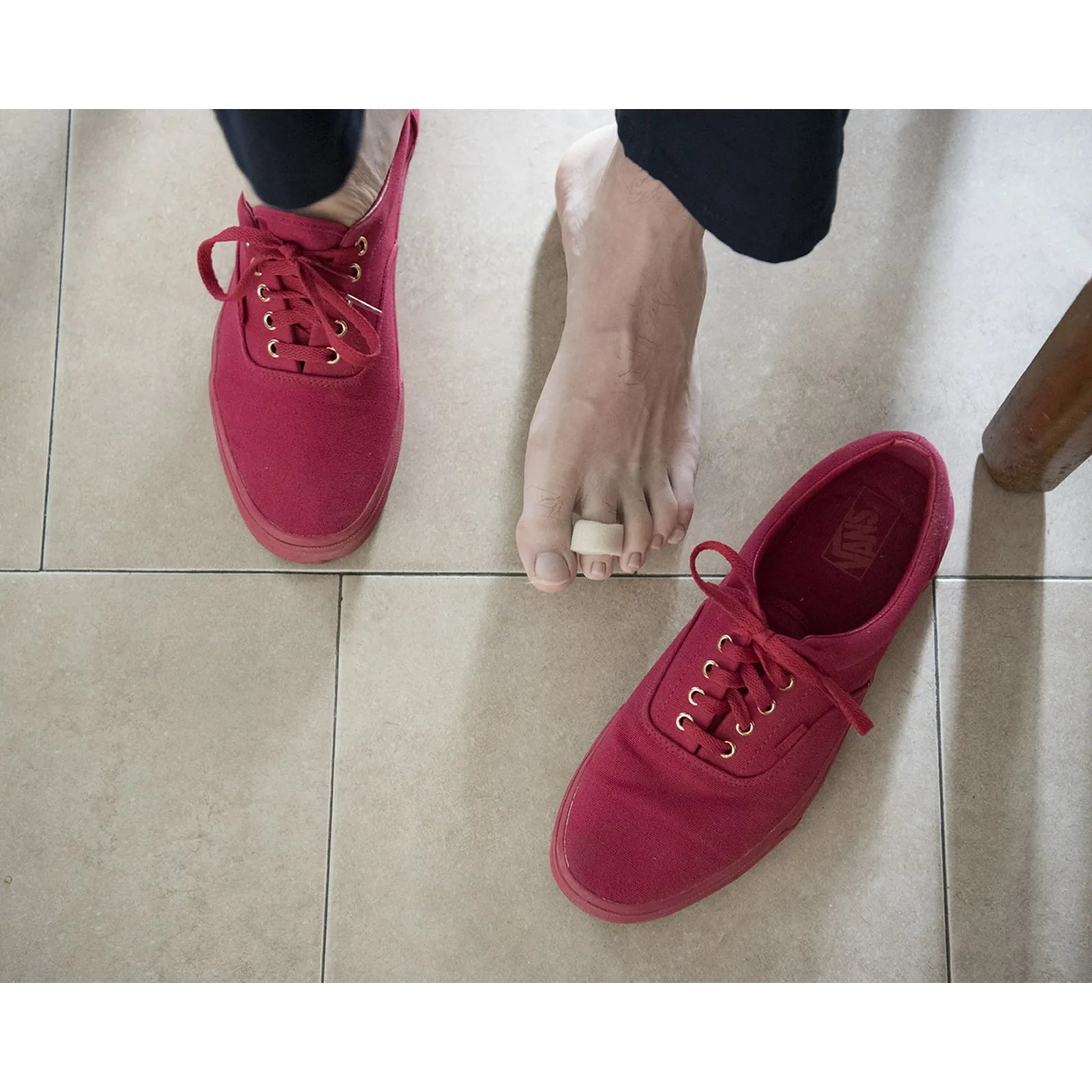 Cushioned foam ProFoot toe bandage worn on a toe next to shoes