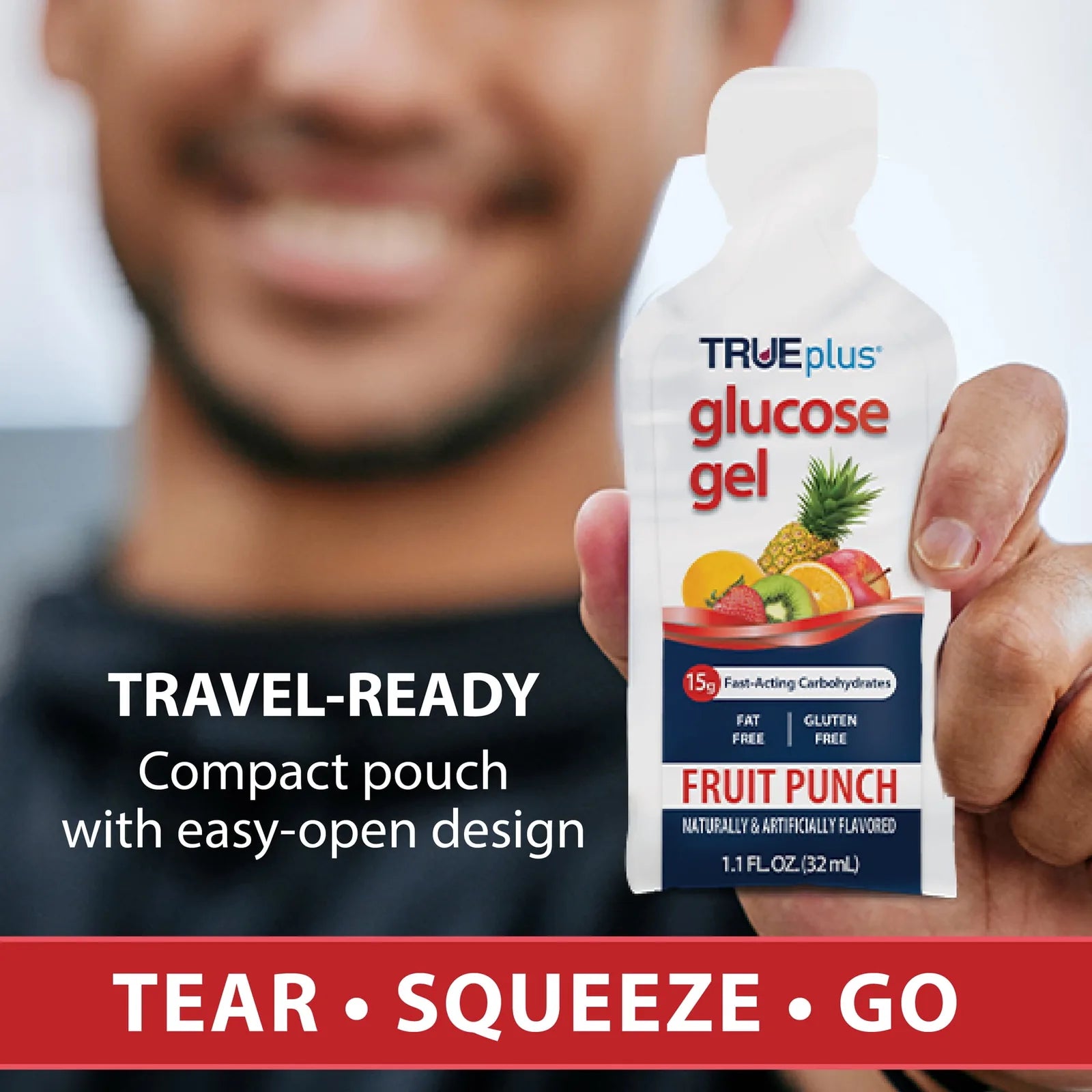 Person holding a travel-ready TRUEplus glucose gel fruit punch pouch with easy-open design
