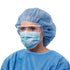 Healthcare worker in cap, gown, and Cardinal Health surgical mask