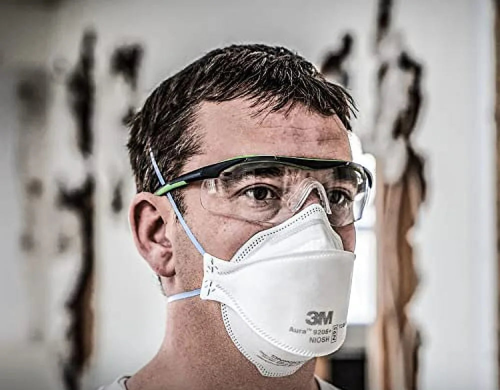 Person wearing the 3M Aura 9205 Plus N95 respirator with safety glasses