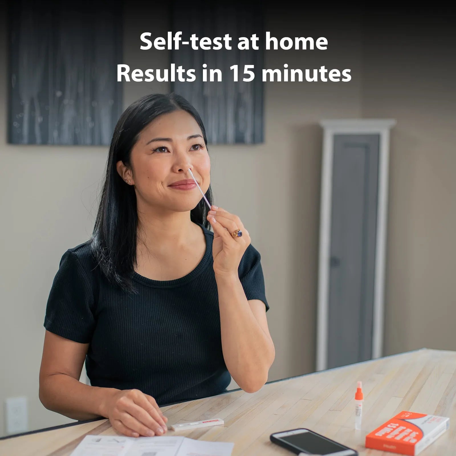 Woman taking an iHealth COVID-19 rapid self-test at home with results in 15 minutes