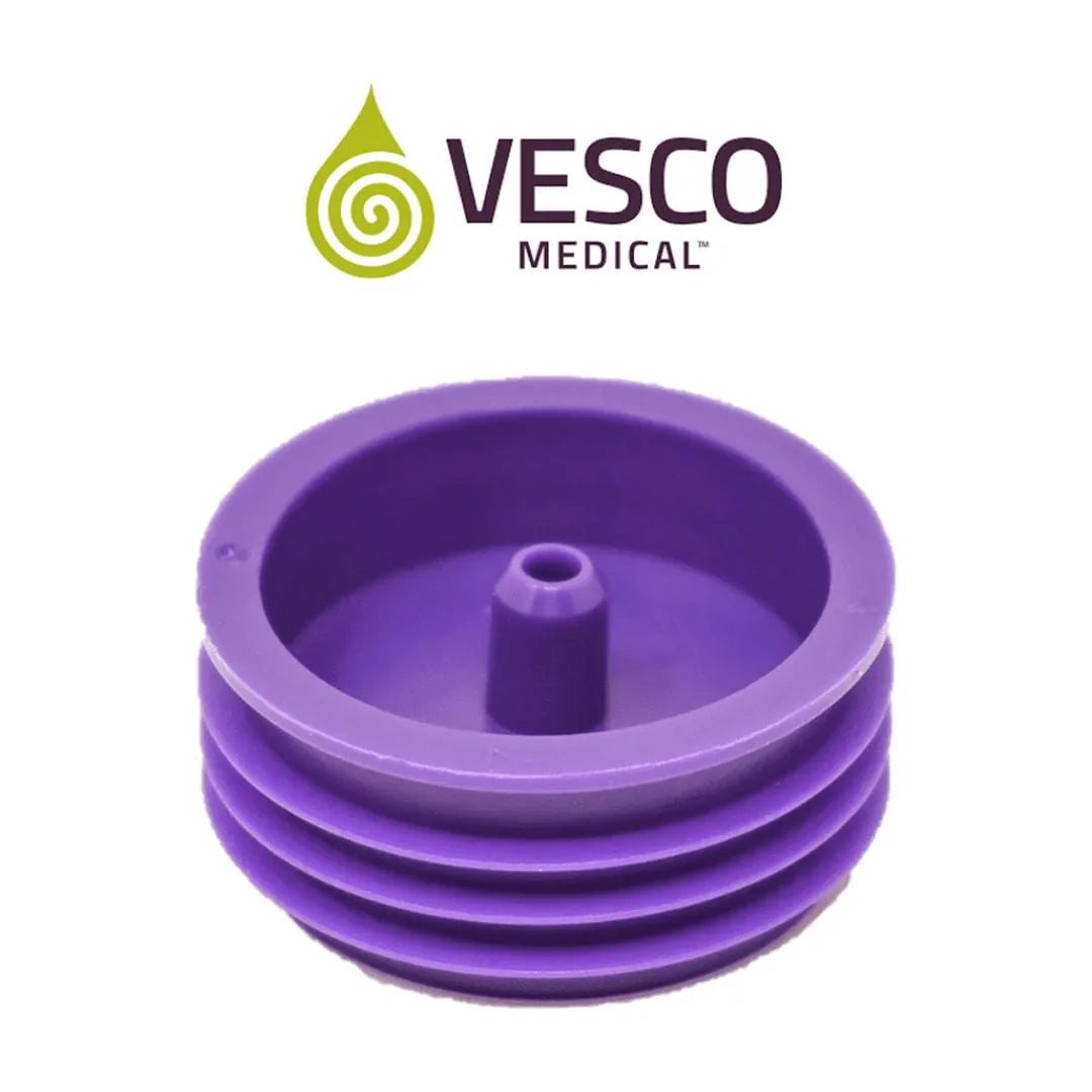 Close-up of a single purple Vesco Medical ENFit bottle adapter showing the ridged body and central transfer spout