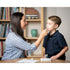 Adult collecting a nasal swab sample from a young child at a kitchen table with the Flowflex COVID-19 antigen home test kit and buffer tube
