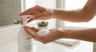 Woman applying Guardelle foaming hand sanitizer showing soft foam in palm