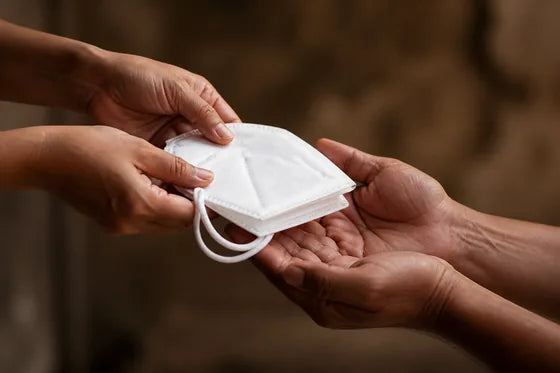 Hands gently passing a bundle of care supplies